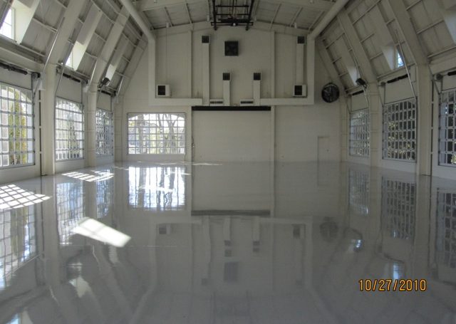 Alan Jackson Garage - white large garage with at least 7 windowed garage doors